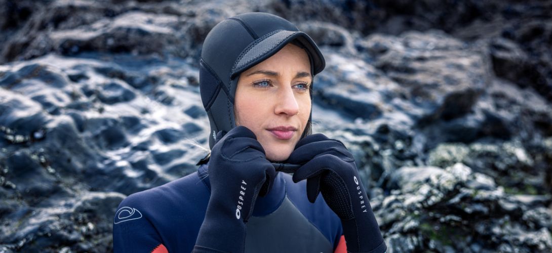 a woman wearing a peaked wetsuit hood