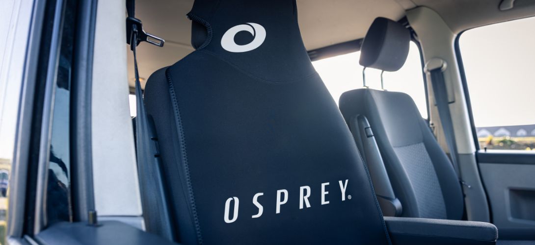 a photo of the Osprey neoprene seat cover on the front seat of a van