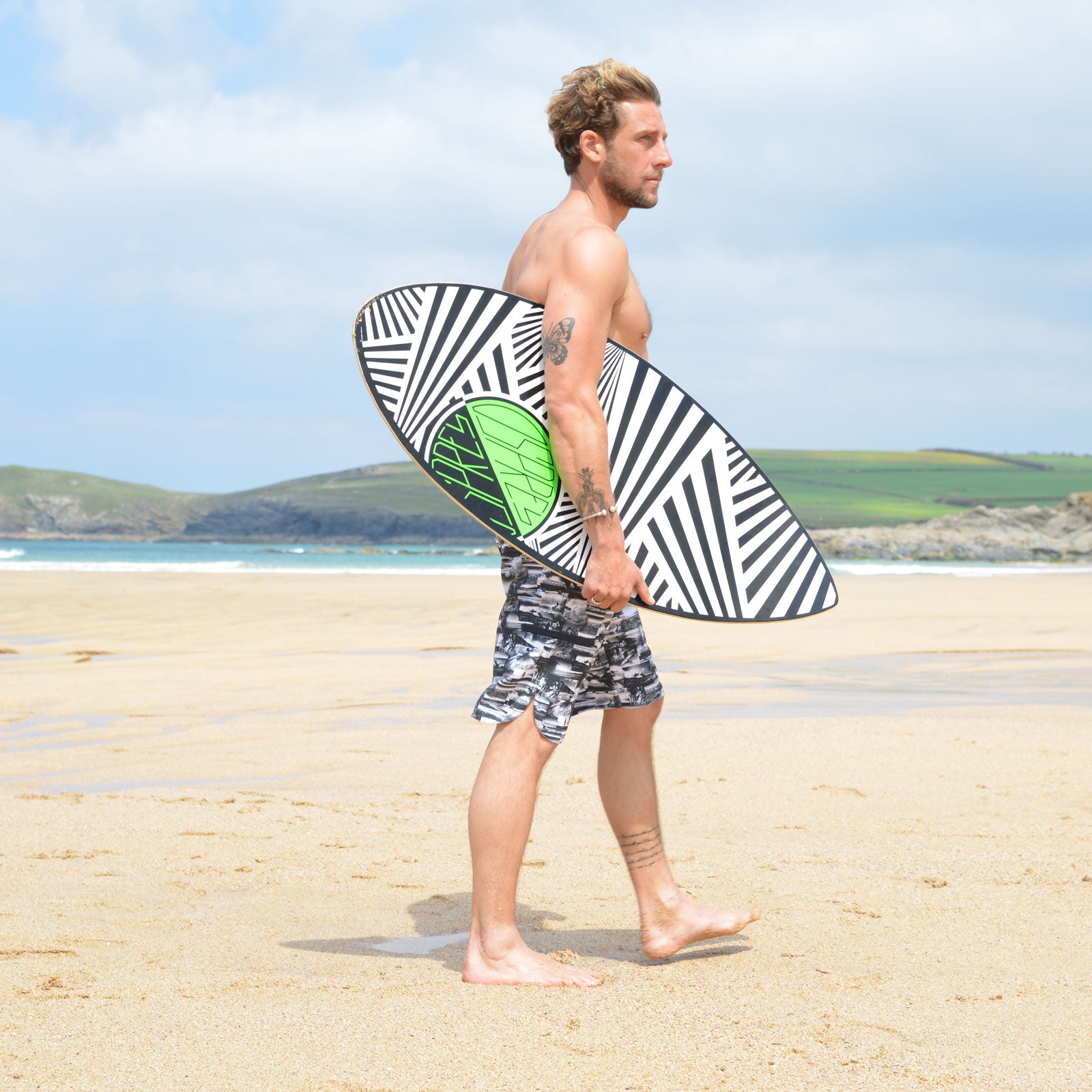 wooden skim board being held by a beginner surfer